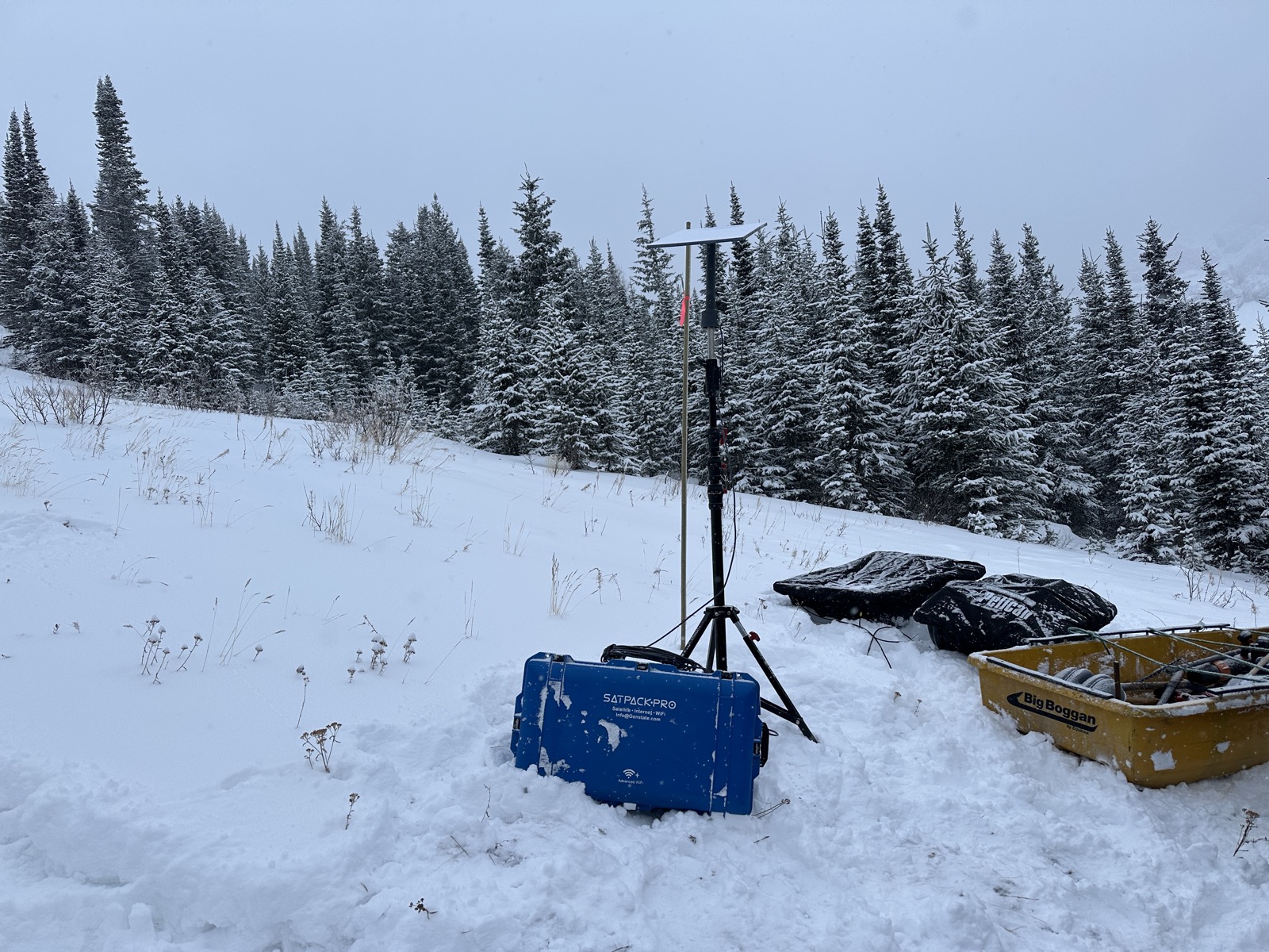 SatPack Pro deployed with tripod antenna in deep mountain snow