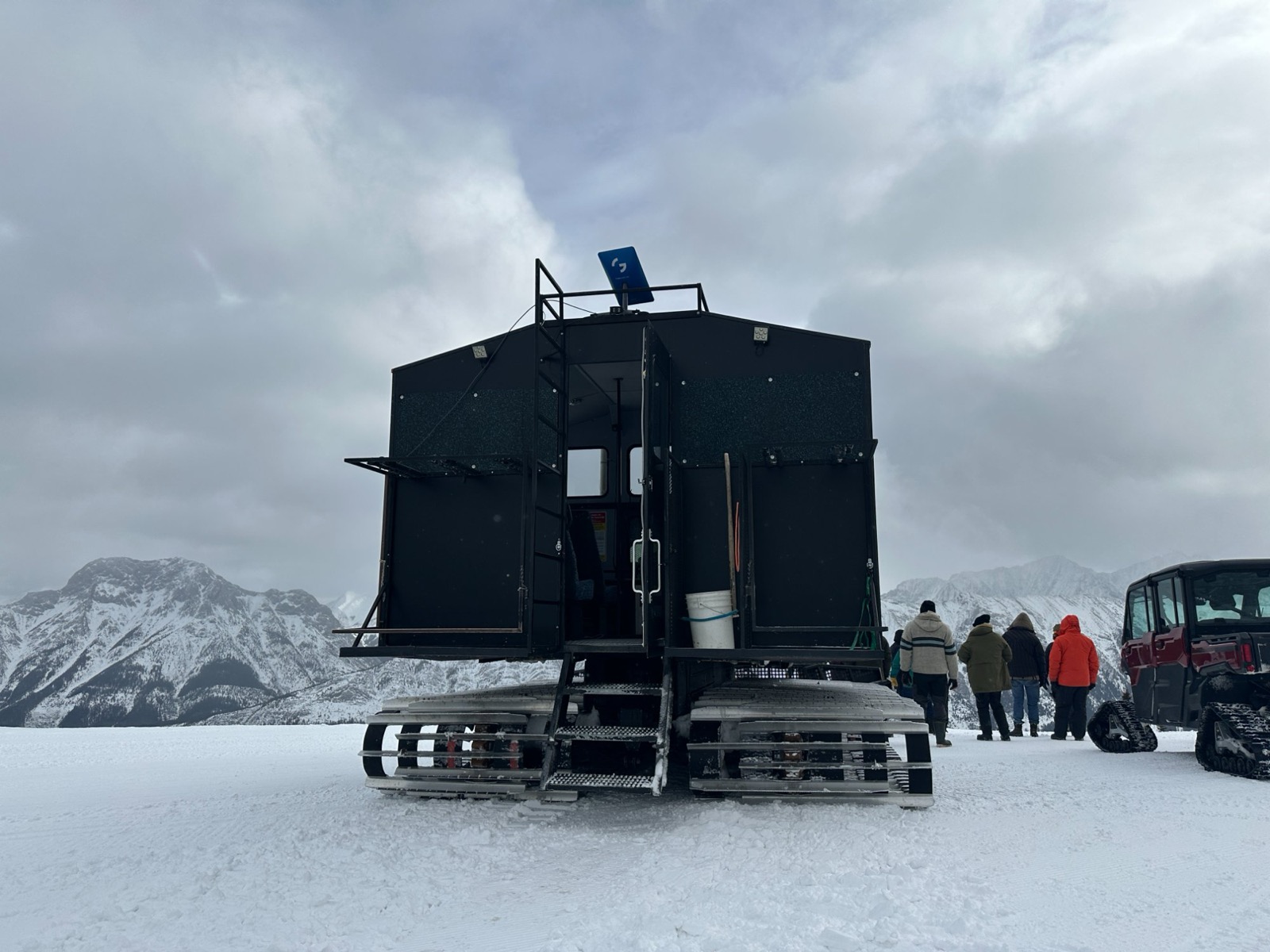 Genstate dish mounted on tracked vehicle in snowy Rocky Mountains